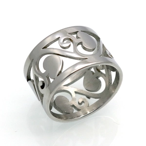 Macro detail of wide hollow-out stainless steel ring with vintage heart and vine engraving