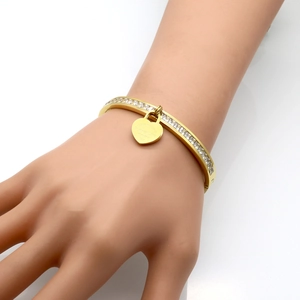 Detail of gold-tone heart lock bracelet with cubic zirconia and Forever Love engraving