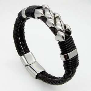 Detail of men's leather braided bracelet with stainless steel shield and magnetic clasp