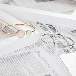 Minimalist gold and silver titanium steel bangles featuring white mother of pearl inlay