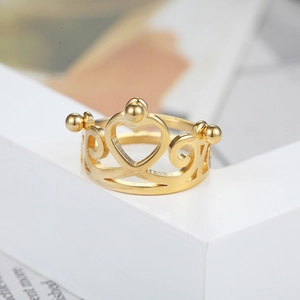 Gold crown heart ring for women with minimalist romantic design on a white pedestal