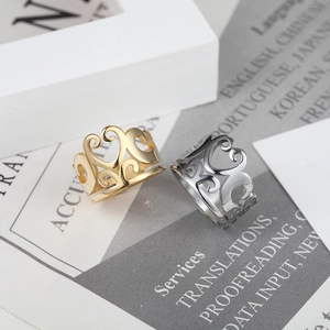 Retro hollow heart crown rings in gold and silver finish on a grey textured background