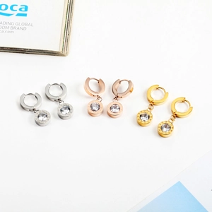 Three pairs of Roman numeral earrings in silver, gold, and rose gold with zircon drops