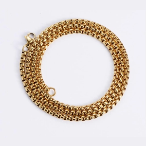 Detailed view of triple-coiled golden box chain necklace with secure lobster clasp closure