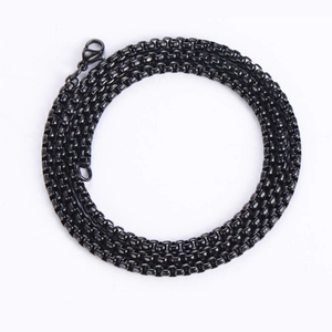 Detail showing a black box chain necklace with a lobster clasp closure on white background
