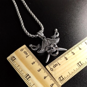 Vintage silver pirate skull necklace with crossed swords on a rustic stainless steel pendant