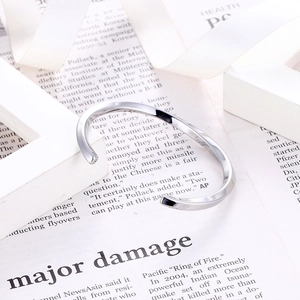 Modern silver Mobius twist open bangle in minimalist stainless steel for men and women