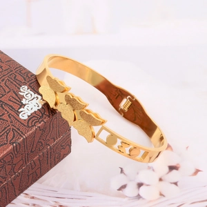 Elegant gold butterfly stainless steel bangle with matte finish on retro jewelry box