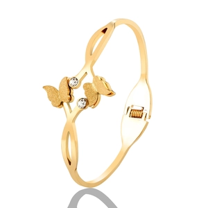 Macro detail of golden stainless steel butterfly bracelet with sparkling zircon accents