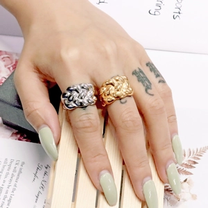 Detail of woven texture rings in gold and silver finish with braided relief patterns