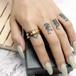 Close-up of rose gold twisted steel ring on finger with elegant jewelry box display