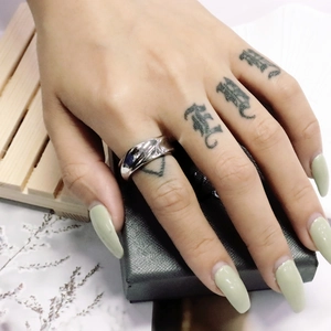Close-up of a wide polished silver titanium steel ring with a high-shine mirror finish