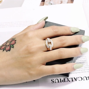 Detailed view of an 18K gold plated double chain ring with shimmering pavé zircon stones