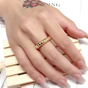 Detail of 18K gold plated croissant dome ring with a polished vintage ripple texture
