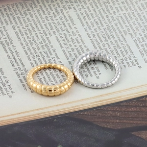 Detail view of gold and silver croissant rings on a vintage book with warm lighting