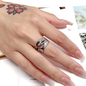 Close-up of irregular streamlined silver ring in polished stainless steel for women