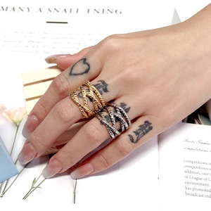 Macro detail of intertwined braided textures on gold and silver stainless steel rings