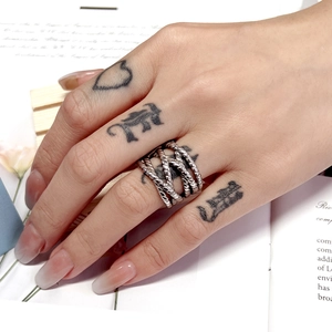 Macro shot of silver layered braided ring with vintage texture on fashion magazine