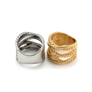Detail of twisted cable and smooth surface texture on gold and silver stainless steel rings