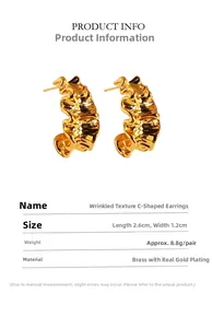Detailed view of gold plated brass C-shaped hoop earrings with wavy wrinkle texture