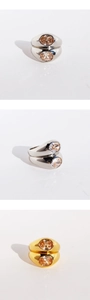 Macro view of wide double-layer rings in gold and silver finish with oval cut gemstones