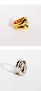 Macro detail of thick irregular gold and silver rings with liquid metal polish finish