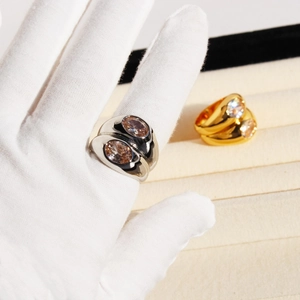 Double-layered wide band ring with large oval center stone in silver and gold plating