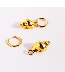Detailed view of detachable gold conch shell pendant earrings with high-polished texture