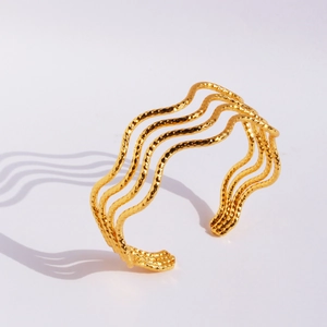 Polished gold plated copper open bangle with textured multi-layer wavy design