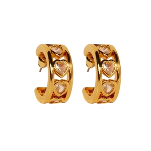 Elegant C-shaped gold hoop earrings featuring hollow heart patterns and zircon stones