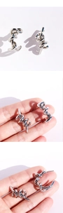 Macro detail of silver twist earrings with irregular wrapped lines and modern C-shape