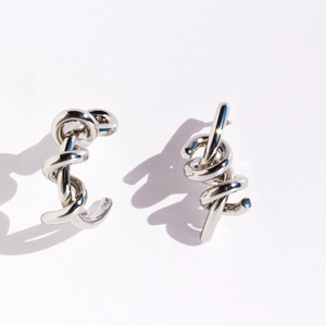 Polished silver asymmetrical twist earrings with creative knotted C-shape design on white
