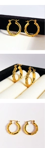 Macro detail of classic gold twisted rope hoop earrings with secure click-top closure