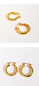 Detail view of gold hoop earrings featuring half-twisted rope and half-smooth metallic texture