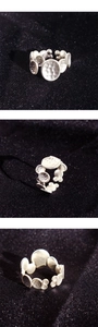 Detailed view of handmade hammered silver ring with irregular circular discs texture