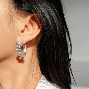 Irregular silver textured pebble C-shaped earrings with a hammered artistic finish