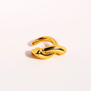 Detail shot of the polished gold knot ear cuff showing high-shine metallic texture