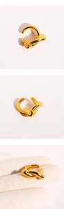 Detailed macro view of gold irregular liquid metal ear cuff with mirror finish texture