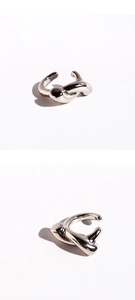 Detail view of silver minimalist knot ear cuff with creative fluid lines and polished finish