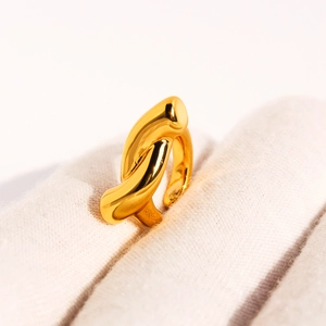Minimalist golden knot ear cuff featuring a polished layered cross-line design for stacking
