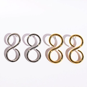 Detailed view of geometric figure 8 stud earrings in polished gold and silver finishes