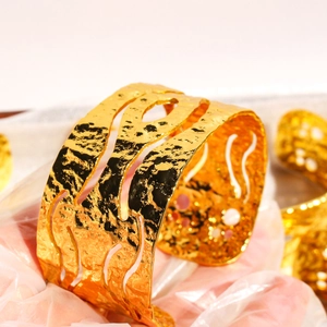 Retro hammered texture open wide cuff bracelet in gold finish with hollow out design