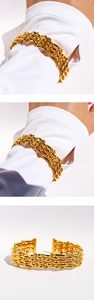 Detail view of bold gold woven chain cuff bracelet with multilayer metal mesh design