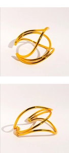Macro shot of gold layered wavy wire cuff bracelet with polished mirror finish details