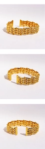 Detailed view of wide gold woven mesh bangle featuring a layered hollow chain design