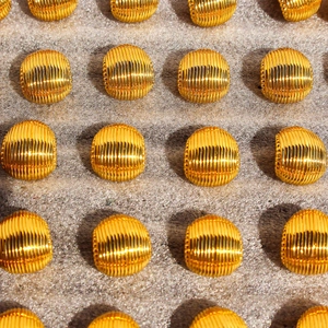 Polished gold shell texture dome stud earrings in a minimalist shell pattern design