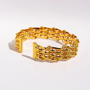 Minimalist gold woven mesh open cuff bracelet with complex layered metallic chain texture