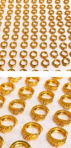 Detailed close-up of golden twisted hoop earrings featuring a square zircon stone inlay