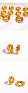 Detailed view of gold twisted hoop earrings with a square-cut zircon stone inlay