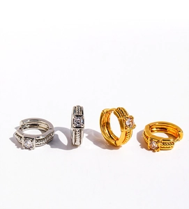 Close-up of twisted rope hoop earrings with square zircon in gold and silver plating
